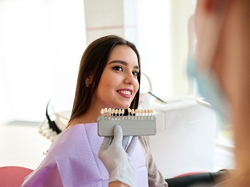 Patient listening as dentist discusses dental bonding
