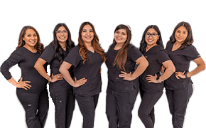 Six smiling Garland dental team members