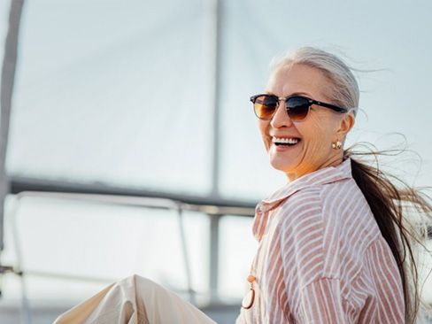 a mature woman smiling with her new dentures