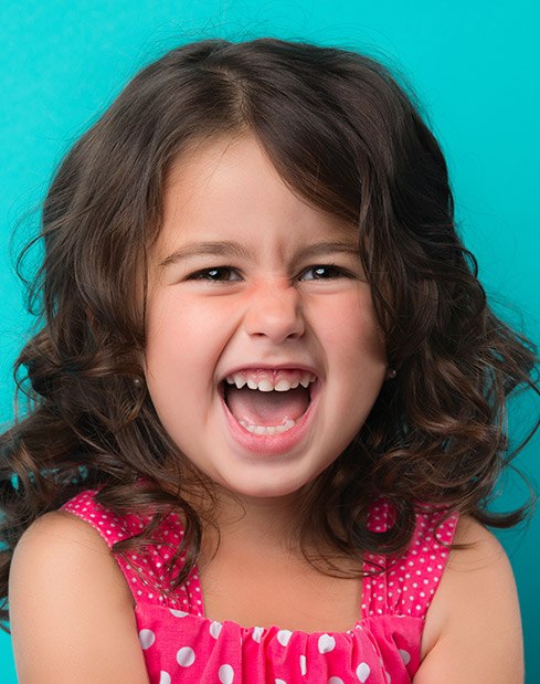 Laughing young girl after children's dentistry visit