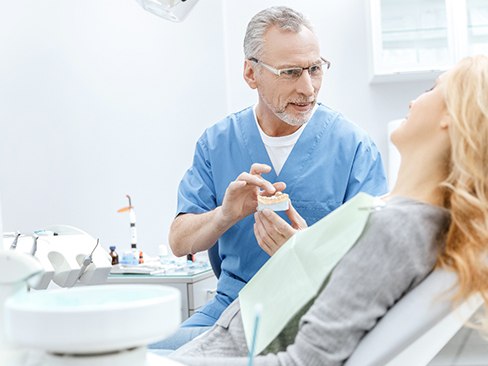 Dentist with patient during dental implant treatment consultation