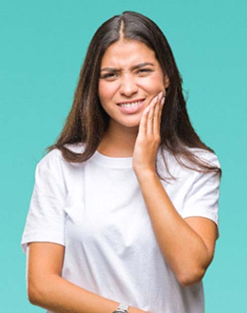 Woman with a toothache in Garland touching her face