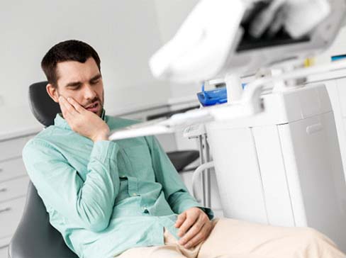 Man thinking about the cost of dental emergencies in Garland