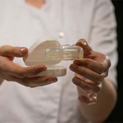 Close-up of hands holding a mouthguard and protective case