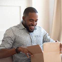 Man smiling in looking in an open box