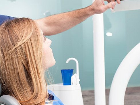 Dentist and patient looking at dental x-rays before tooth extractions