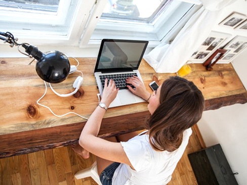 A woman working on a laptop computer