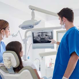 dentist showing a patient their X-rays