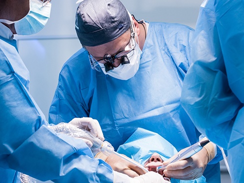 A team of dentists finishing a dental implant surgery