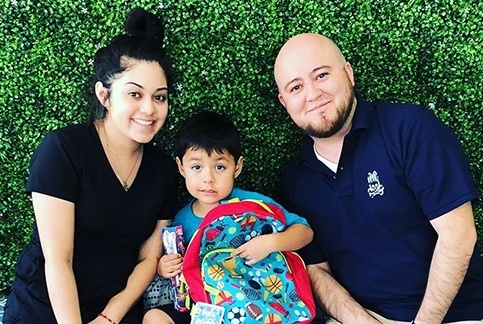 Team members and child smiling together