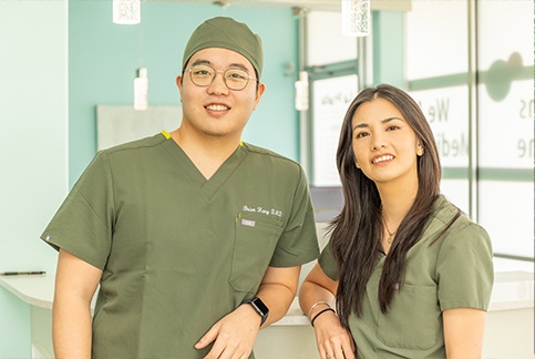 Two smiling Garland dental team members