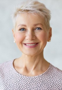 Mature woman in polka dot shirt smiling