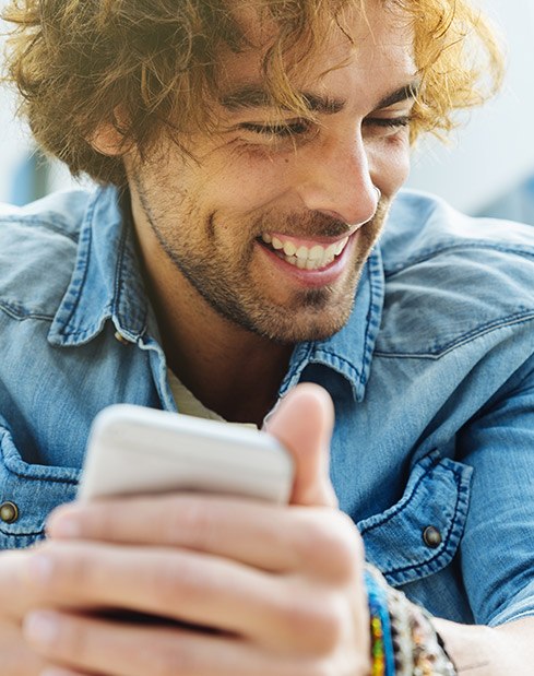 Laughing man with healthy smile after periodontal disease treatment