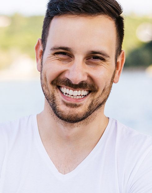 Man smiling after root canal therapy