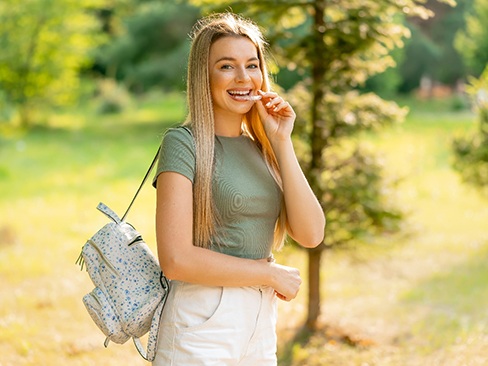 Teenage girl wearing Invisalign in Garland