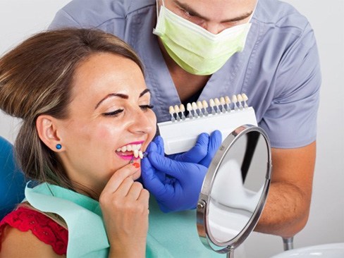 woman trying on veneers from her cosmetic dentist in Garland  