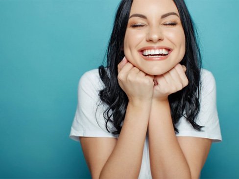 woman grinning from ear to ear  