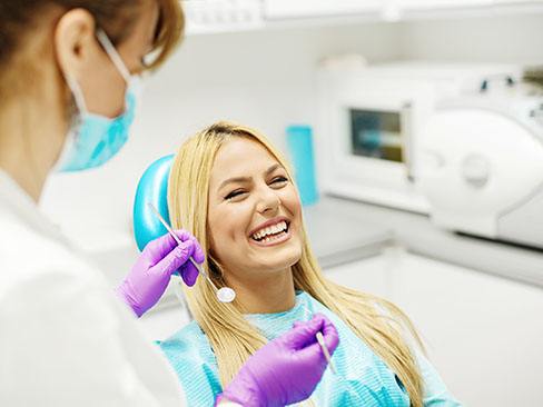 Laughing woman in dentist’s chair