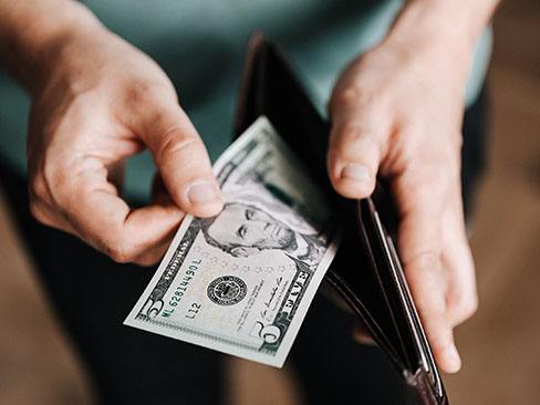 Man pulling cash out of wallet