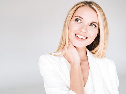 a woman smiling after getting veneers in Garland