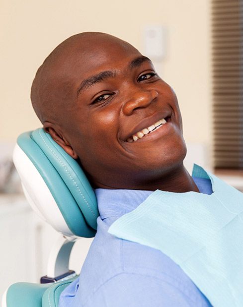 Young man smiling after wisdom tooth exractions