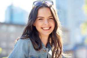 happy young woman smiling after cosmetic dental treatments 
