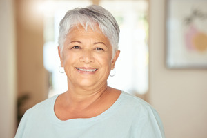 Senior woman in light blue shirt smiling