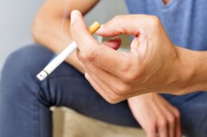 Close up of man’s hand holding cigarette 
